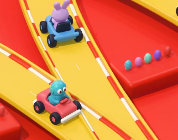 Zwei bunte Cartoon-Karts mit Fantasiefiguren auf einer gelben Rennstrecke mit rot-weißen Randstreifen